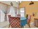 Cozy dining area with traditional furnishings, a round table, and natural light streaming through the windows at 651 Regina Cir, Oakland, FL 34787