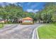The community entrance is marked by lush landscaping, a guard house, and paved roads at 651 Regina Cir, Oakland, FL 34787