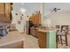 Well-equipped kitchen featuring wooden cabinetry, stainless steel appliances, and a breakfast bar at 651 Regina Cir, Oakland, FL 34787