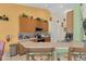 Well-equipped kitchen featuring wooden cabinetry, stainless steel appliances, and a breakfast bar at 651 Regina Cir, Oakland, FL 34787