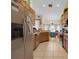 Spacious kitchen featuring stainless steel appliances, tiled floor, wood cabinets, and an eat-in area at 651 Regina Cir, Oakland, FL 34787
