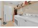 Functional laundry room equipped with modern washer and dryer units and ample storage space at 651 Regina Cir, Oakland, FL 34787