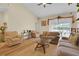 Bright and airy living room with vaulted ceilings, neutral decor, and sliding doors to the outdoor area at 651 Regina Cir, Oakland, FL 34787