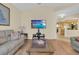 Cozy living room featuring wood floors, a large wall-mounted TV, and comfortable seating at 651 Regina Cir, Oakland, FL 34787