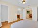 Serene main bedroom featuring wood floors and views into the en-suite bathroom and breakfast nook at 651 Regina Cir, Oakland, FL 34787