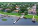 Scenic view of waterfront homes boasting private docks, lush greenery, and serene lake access for luxurious living at 651 Regina Cir, Oakland, FL 34787