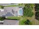 Aerial view of a home showcasing a screened pool, backyard, and solar panels on the roof at 6808 Goldflower Ave, Harmony, FL 34773
