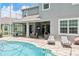 Backyard with a pool, patio furniture, and a ping pong table at 6808 Goldflower Ave, Harmony, FL 34773