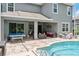 Backyard featuring a pool, patio furniture, and a ping pong table at 6808 Goldflower Ave, Harmony, FL 34773