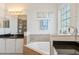 Beautiful bathroom featuring granite countertops, white cabinetry, and a relaxing garden tub at 6808 Goldflower Ave, Harmony, FL 34773
