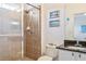 Bathroom featuring a large walk-in shower, granite vanity, and mirror at 6808 Goldflower Ave, Harmony, FL 34773