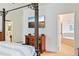 Primary suite with four poster bed, TV, wood furniture, and ensuite bathroom with garden tub at 6808 Goldflower Ave, Harmony, FL 34773