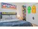Bedroom with a scarf on the headboard, and soccer jerseys on the wall at 6808 Goldflower Ave, Harmony, FL 34773