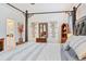 Bedroom boasting a four-poster bed frame, wood furnishings, and stylish decor at 6808 Goldflower Ave, Harmony, FL 34773