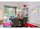 Elegant dining room with stylish decor, statement lighting, and a clear view to the outdoor screened recreation area at 6808 Goldflower Ave, Harmony, FL 34773