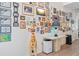 Bright hallway featuring tile flooring, a decorative giraffe, and a wall adorned with framed pictures at 6808 Goldflower Ave, Harmony, FL 34773