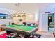 Spacious game room with a pool table, flat screen television and decoratively lit soffits at 6808 Goldflower Ave, Harmony, FL 34773