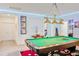 Game room featuring a beautiful pool table, light fixtures, and access to other rooms at 6808 Goldflower Ave, Harmony, FL 34773