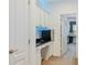 Hallway with white cabinets and countertops and opens up to another room at 6808 Goldflower Ave, Harmony, FL 34773