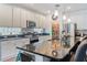 Inviting kitchen with island seating, stainless appliances, and pantry, ideal for entertaining and culinary enthusiasts at 6808 Goldflower Ave, Harmony, FL 34773