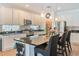 Spacious kitchen with white cabinetry, a large island, and stainless steel appliances at 6808 Goldflower Ave, Harmony, FL 34773