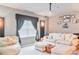 Comfortable living room with a large couch, overstuffed ottoman, and built in media at 6808 Goldflower Ave, Harmony, FL 34773