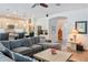 Open-concept living space with a comfortable sectional and view into the kitchen at 6808 Goldflower Ave, Harmony, FL 34773