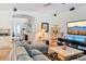 Cozy living room with a plush sectional, modern decor, and lots of natural light at 6808 Goldflower Ave, Harmony, FL 34773