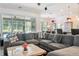 Spacious living area with a gray sectional and views of the pool at 6808 Goldflower Ave, Harmony, FL 34773