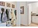 Organized mudroom with hooks, shoe storage, and adjacent laundry room, providing practical entry and storage solutions at 6808 Goldflower Ave, Harmony, FL 34773