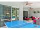 Covered patio with ceiling fans and furniture, offering a comfortable outdoor living space with entertainment options at 6808 Goldflower Ave, Harmony, FL 34773