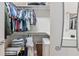 Spacious walk-in closet with custom shelving and clothes rods for organizing a wardrobe at 6808 Goldflower Ave, Harmony, FL 34773