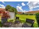 Relaxing backyard patio area with seating, overlooking a well-maintained green space at 7638 Long Island Dr, Kissimmee, FL 34747