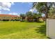 Expansive backyard view showcasing lush green space and the property's exterior at 7638 Long Island Dr, Kissimmee, FL 34747