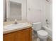 Bathroom with vanity, sink, toilet, and a shower-tub combination with white tiled walls at 7638 Long Island Dr, Kissimmee, FL 34747