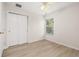 Cozy bedroom boasts light wood flooring and a double door closet, illuminated by a natural light from a window at 7638 Long Island Dr, Kissimmee, FL 34747