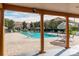 Inviting community pool with brick patio, lounge chairs, and umbrellas for relaxing at 7638 Long Island Dr, Kissimmee, FL 34747