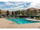 Beautiful community pool area with lounge chairs and well-maintained landscaping at 7638 Long Island Dr, Kissimmee, FL 34747