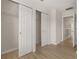 Hallway featuring a double closet, light wood flooring, and doorway entrances to other rooms at 7638 Long Island Dr, Kissimmee, FL 34747