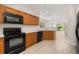 Eat in kitchen with stainless steel appliances and tiled floor at 7638 Long Island Dr, Kissimmee, FL 34747