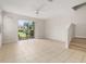 Open-concept living area with a ceiling fan and sliding glass doors to outdoor space at 7638 Long Island Dr, Kissimmee, FL 34747