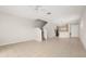 Open-concept living room featuring tile flooring, a chandelier, and stairway access at 7638 Long Island Dr, Kissimmee, FL 34747