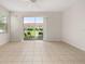Bright living room with tiled floors, ceiling fan, and sliding doors to a patio at 7638 Long Island Dr, Kissimmee, FL 34747