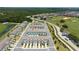 Aerial perspective of the community showcasing its townhouses, pool area, and proximity to a golf course and natural surroundings at 7920 Draw St, Reunion, FL 34747