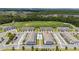 Elevated view capturing the community's townhouses, central pool, and golf course surroundings, emphasizing recreational opportunities at 7920 Draw St, Reunion, FL 34747