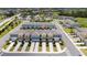 Aerial view showcasing the community's colorful townhouses, green spaces, and convenient parking, emphasizing the desirable location at 7920 Draw St, Reunion, FL 34747