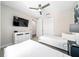 Bright bedroom with twin beds, dresser, ceiling fan, closet and tv at 7920 Draw St, Reunion, FL 34747