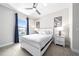 Bedroom with a queen-size bed, ceiling fan, nightstands, lamps, and window view at 7920 Draw St, Reunion, FL 34747