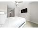 Comfortable bedroom featuring queen size bed, ceiling fan, and ensuite bathroom at 7920 Draw St, Reunion, FL 34747