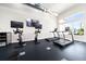 Community gym featuring treadmills, stationary bikes, and large windows with pool views at 7920 Draw St, Reunion, FL 34747